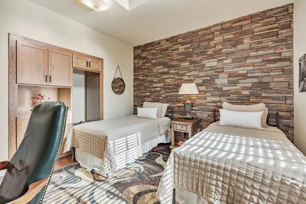 a bedroom with a bed mirror and a window