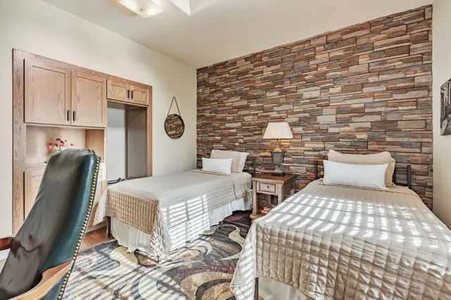 a bedroom with a bed mirror and a window