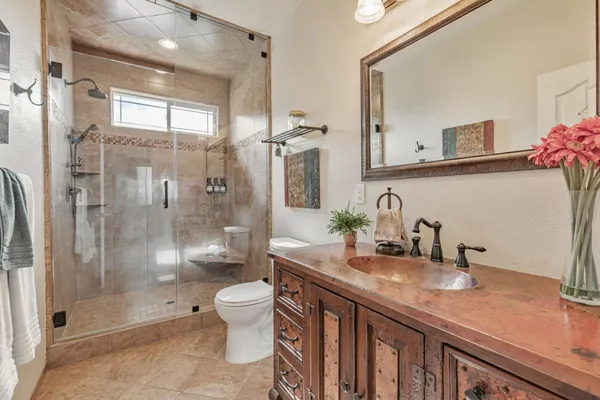 a view of a patio with a table and chairs under an umbrella