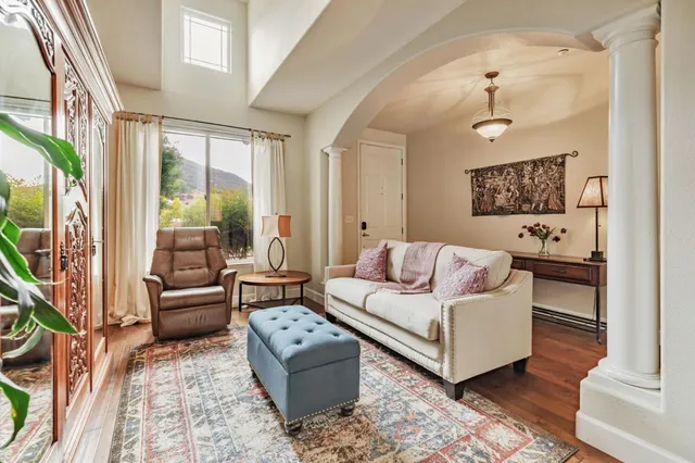 a living room with furniture a clock and a fireplace