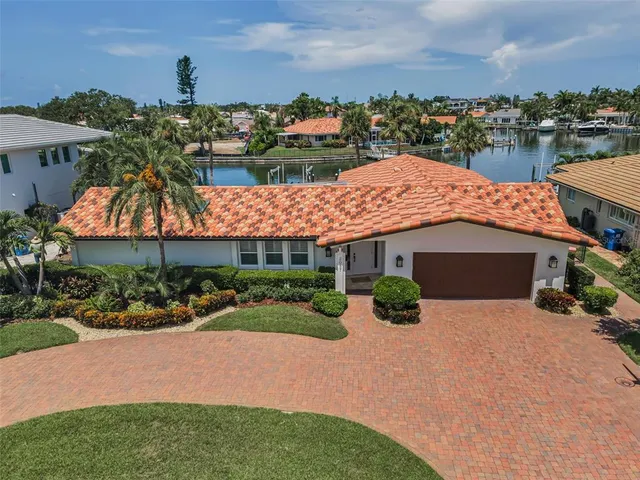 an aerial view of a house with yard and lake view