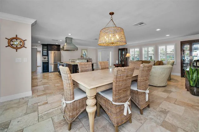 a large kitchen with stainless steel appliances granite countertop a sink and a refrigerator