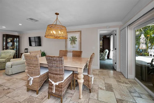 a kitchen with stainless steel appliances a dining table chairs and granite counter tops