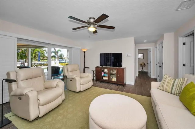 a spacious bedroom with a bed and a flat screen tv