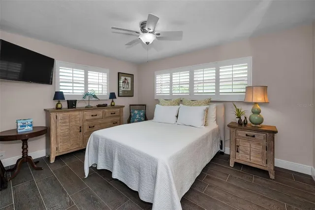a view of a livingroom with furniture a rug and a large window