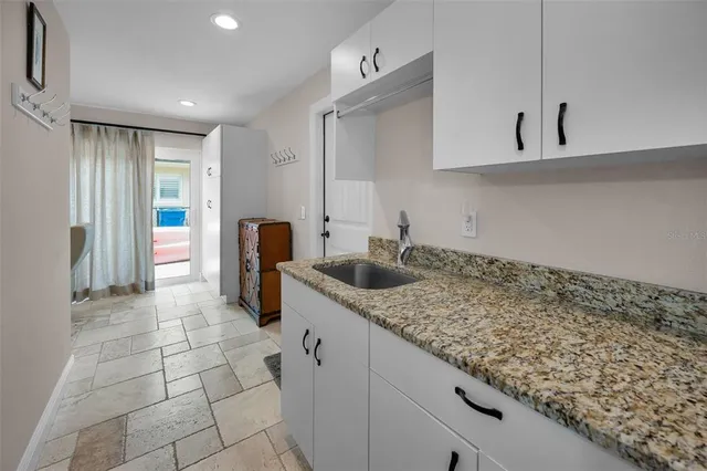 a view of swimming pool with a table and chairs