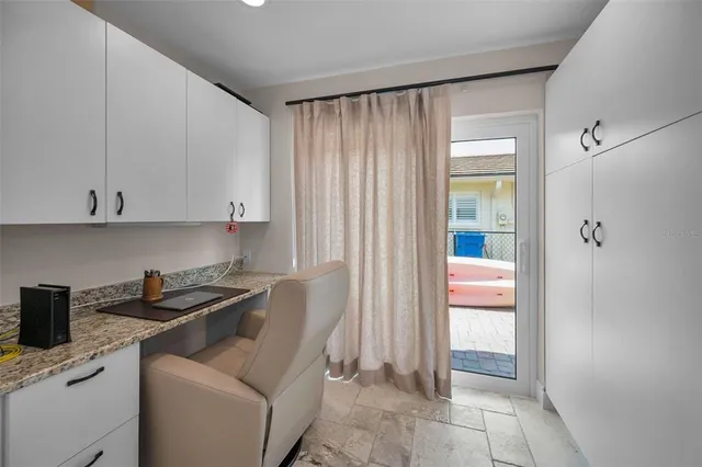 a view of a house with swimming pool lawn chairs and a yard