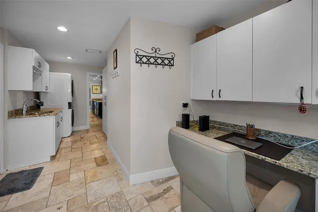 a view of a house with sitting area and swimming pool