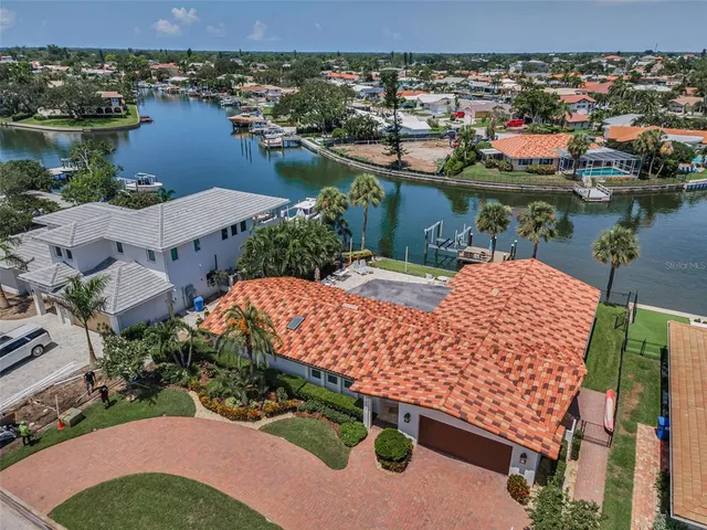 a view of a house with a yard and potted plants