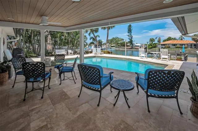 a view of a house with swimming pool and porch