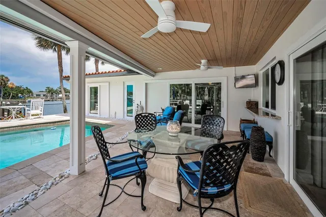 a view of a chairs and table in patio with a lake view