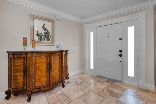 a living room with furniture a flat screen tv and kitchen view
