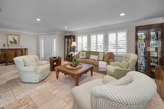 a living room with lots of furniture and kitchen view