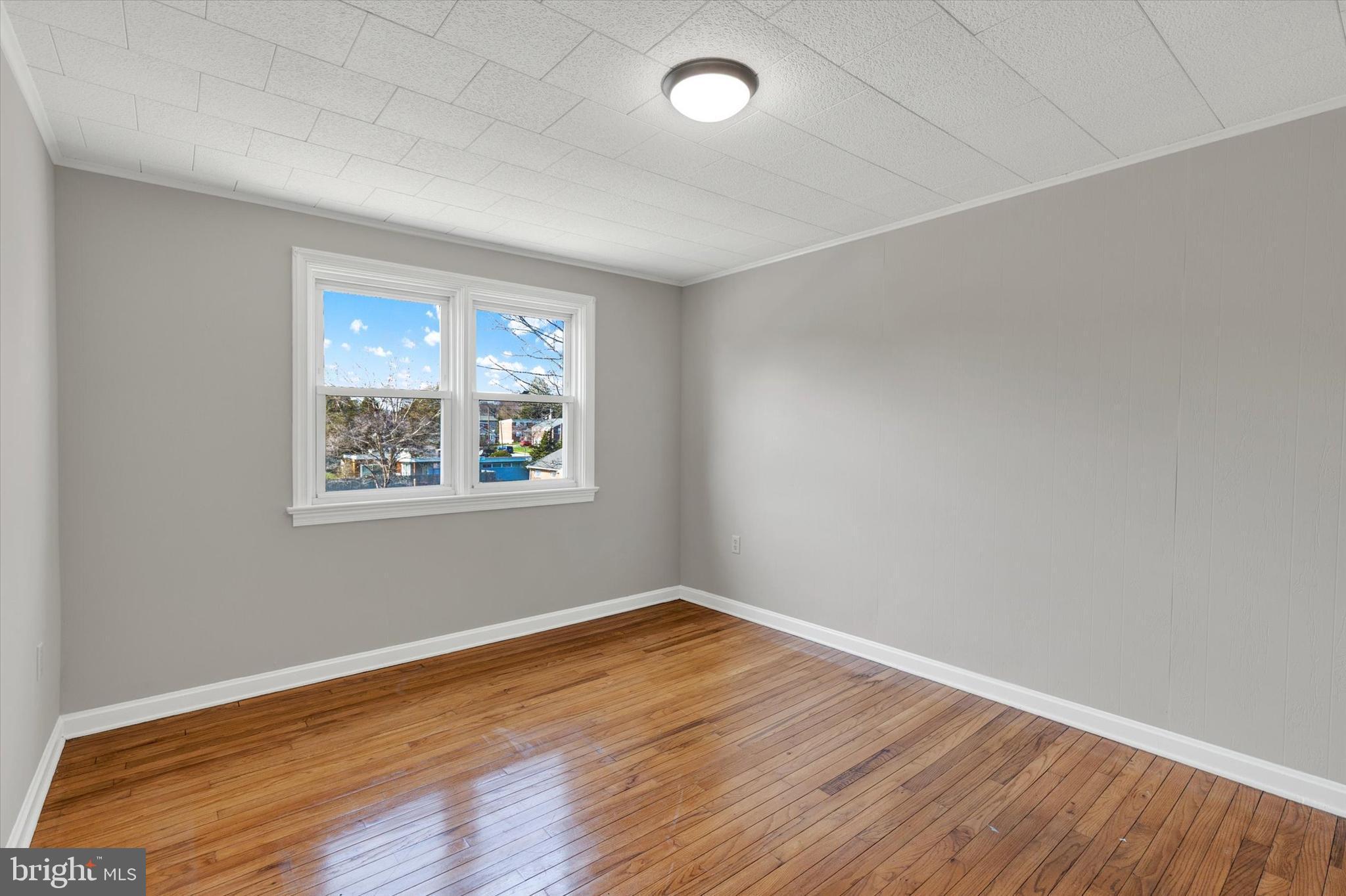 1218 Fremont Street Lancaster, PA 17603 - Photo 13 of 24 an empty room with wooden floor and windows