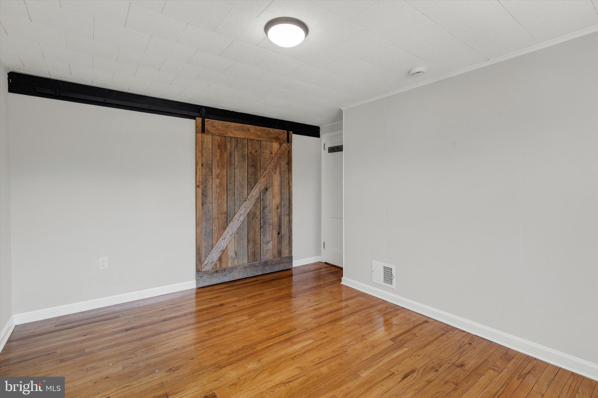 1218 Fremont Street Lancaster, PA 17603 - Photo 17 of 24 wooden floor in an empty room with a window