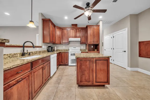 an empty room with a ceiling fan and window