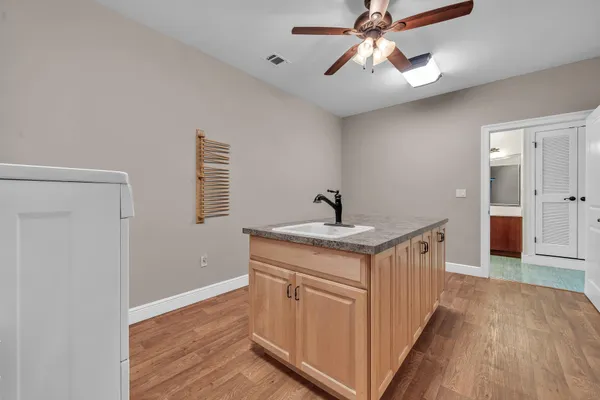 a bathroom with a granite countertop shower and a toilet