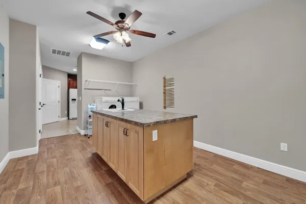 a bathroom with a tub a sink and a window
