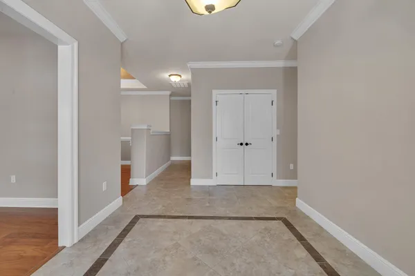 an empty room with ceiling fan and window