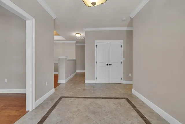 an empty room with ceiling fan and window