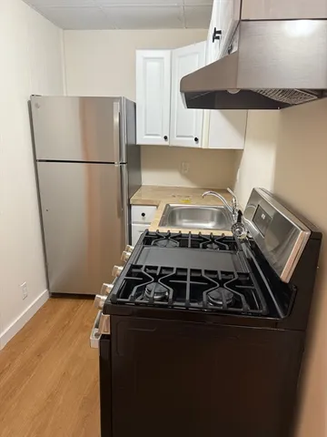 a stove top oven sitting inside of a kitchen