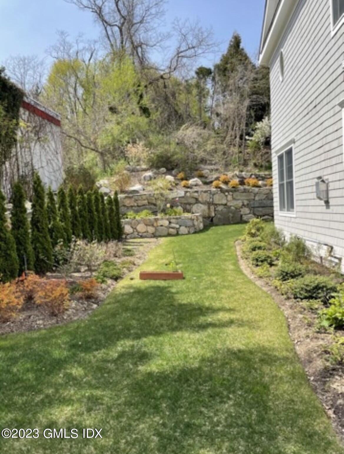 8 Sound Beach Ave Extension, Unit 4 Greenwich, CT 06878 - Photo 22 of 31 a view of a yard with an outdoor space