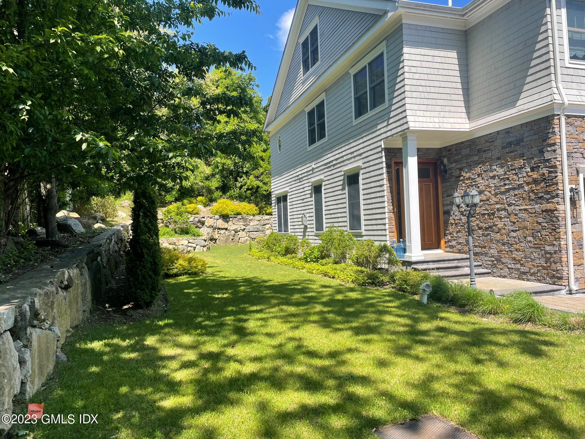8 Sound Beach Ave Extension, Unit 4 Greenwich, CT 06878 - Photo 23 of 31 a view of a house with a yard