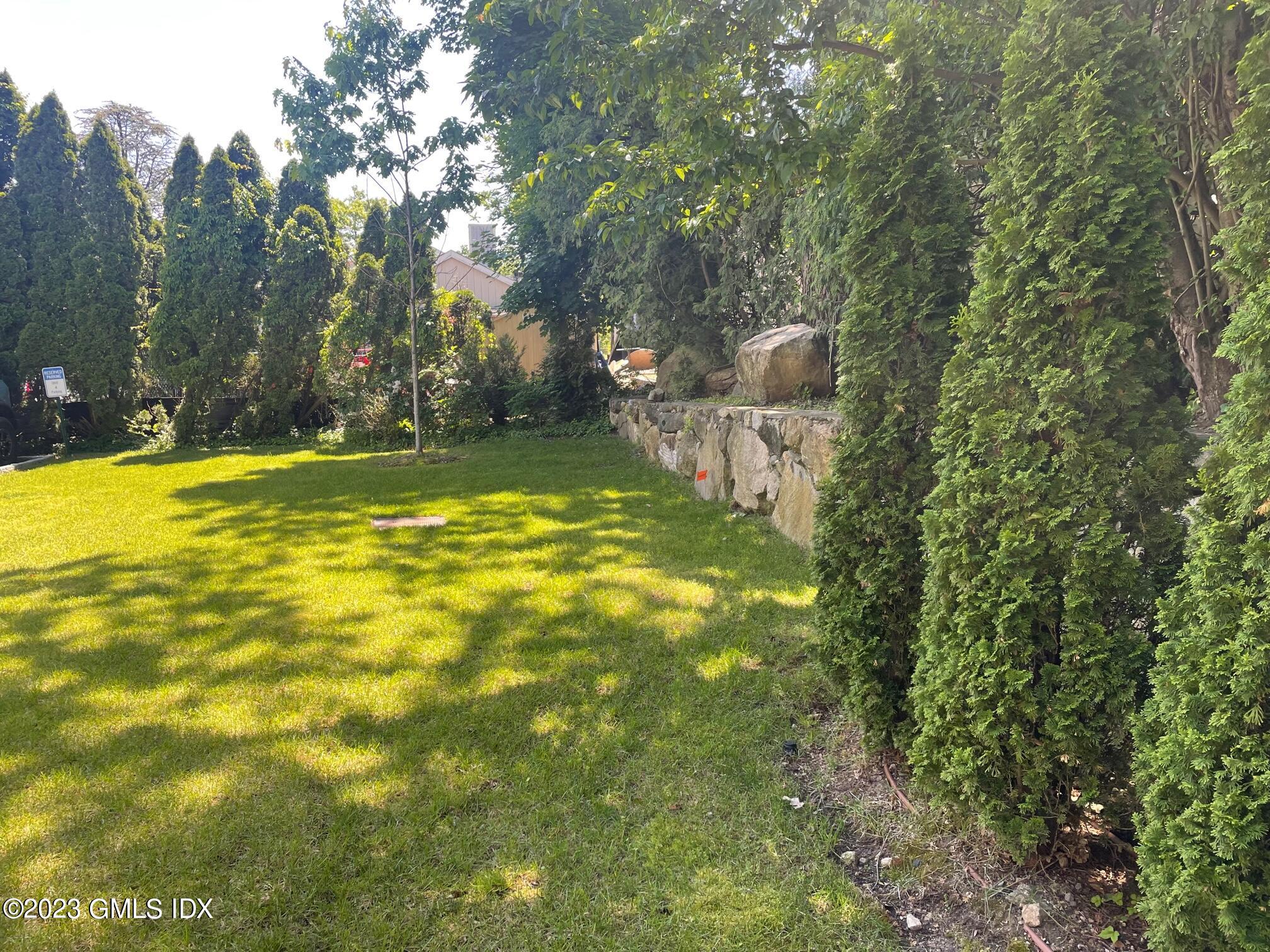 8 Sound Beach Ave Extension, Unit 4 Greenwich, CT 06878 - Photo 24 of 31 a swimming pool with trees in the background