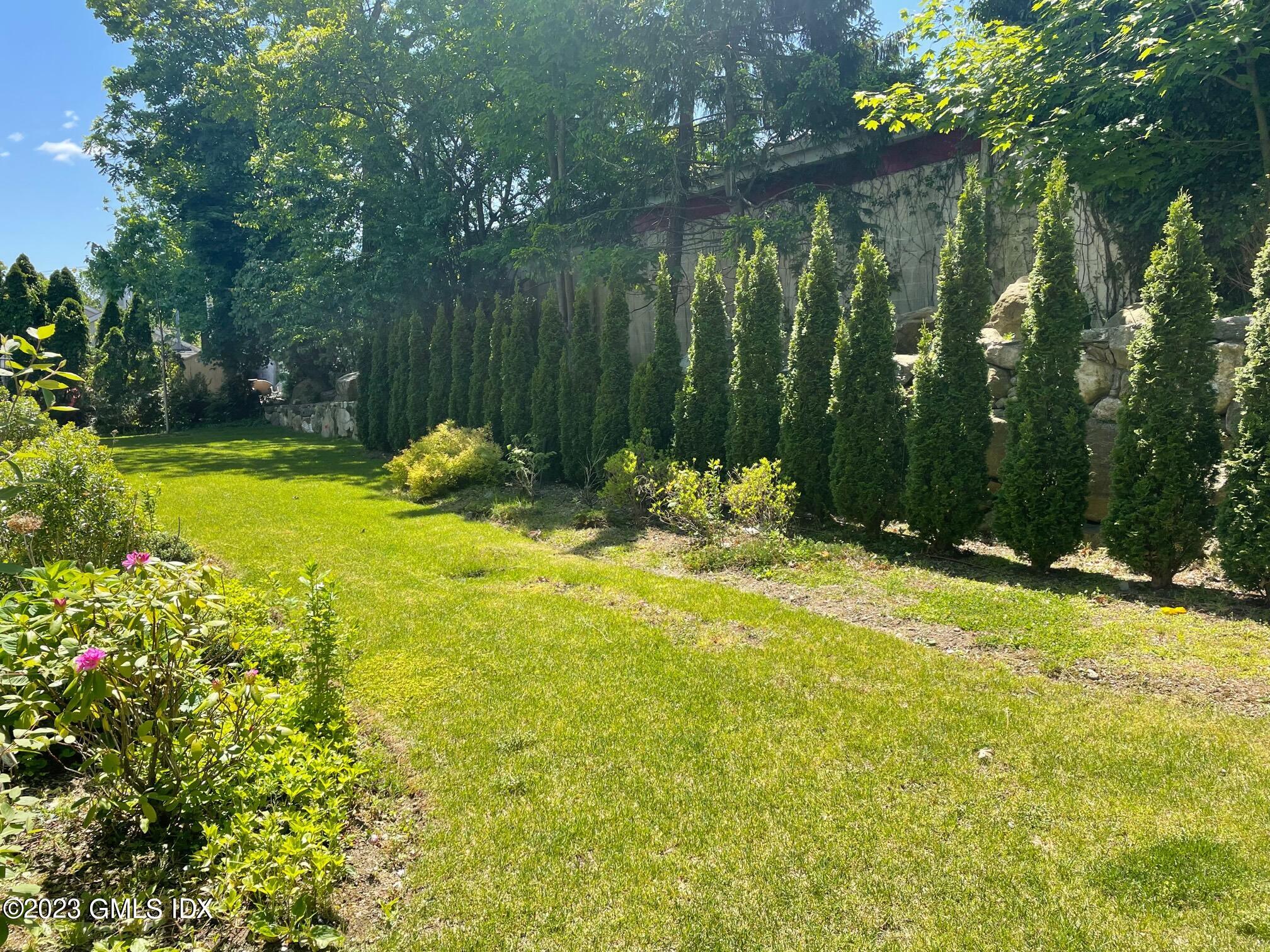 8 Sound Beach Ave Extension, Unit 4 Greenwich, CT 06878 - Photo 25 of 31 a view of backyard with swimming pool and outdoor seating