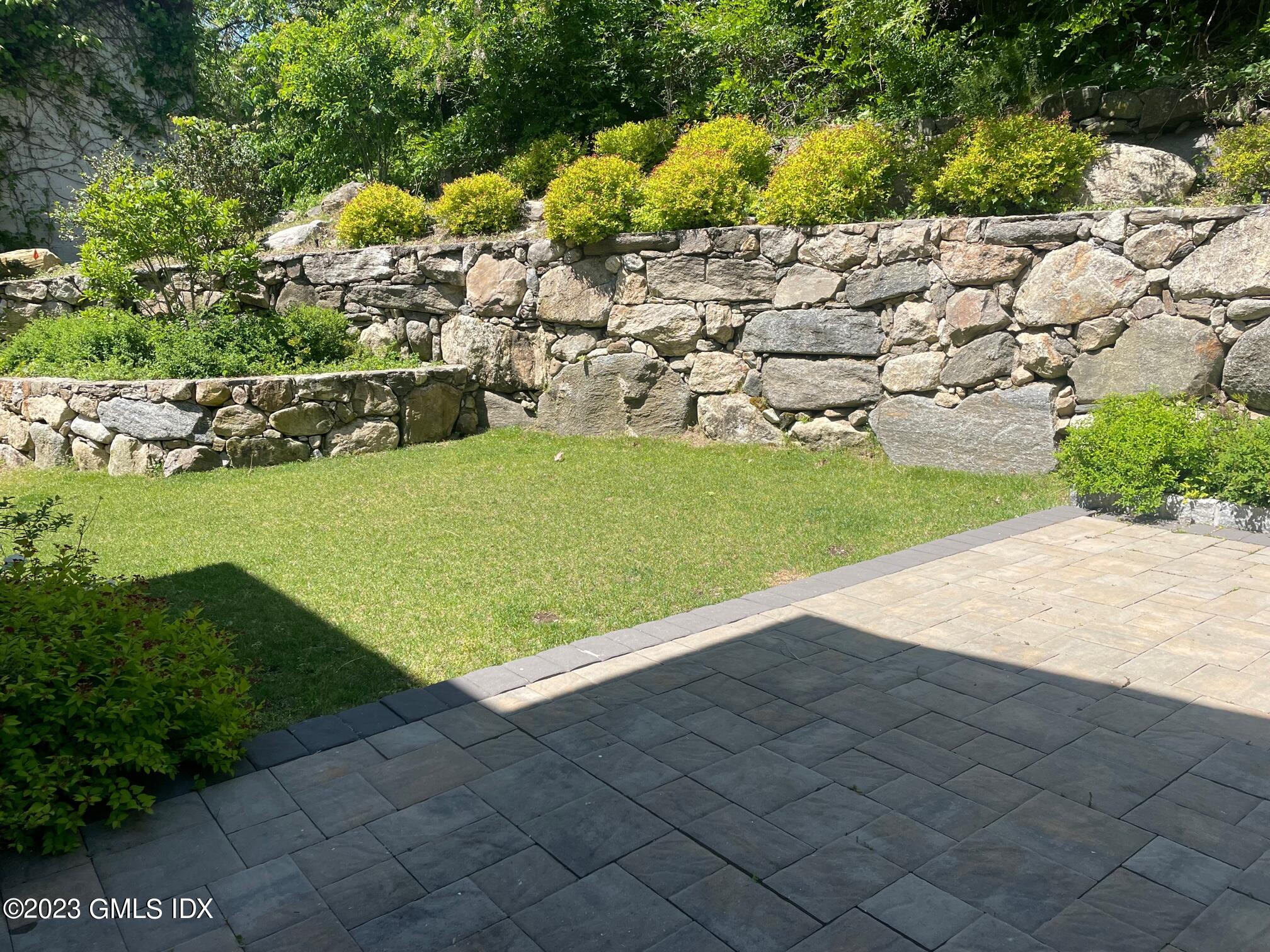 8 Sound Beach Ave Extension, Unit 4 Greenwich, CT 06878 - Photo 26 of 31 a view of a yard and an empty room