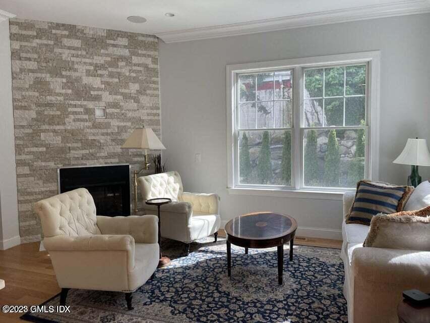 8 Sound Beach Ave Extension, Unit 4 Greenwich, CT 06878 - Photo 6 of 31 a living room with furniture a rug a lamp and a fireplace