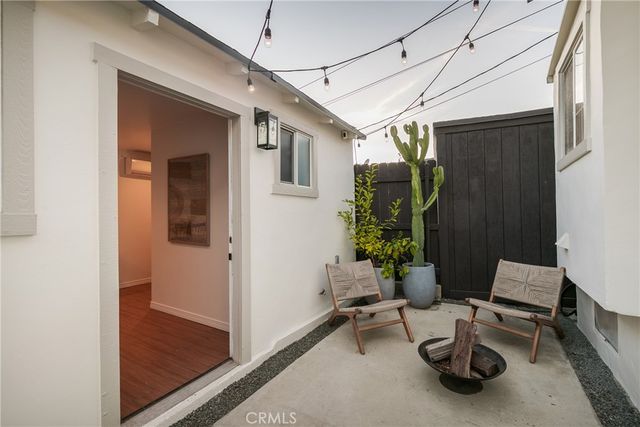a living room with furniture a rug and a window