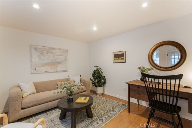 a living room with furniture and flowers