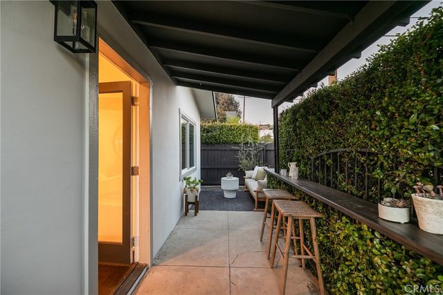a balcony with furniture and a potted plant