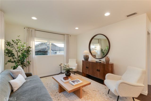 a living room with furniture and a mirror