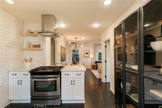 a kitchen with stainless steel appliances a stove a sink and a refrigerator