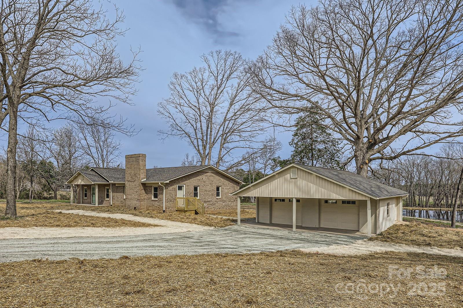 3225 Liberty Road Gold Hill, NC 28071 - Photo 1 of 24 a front view of a house with a yard