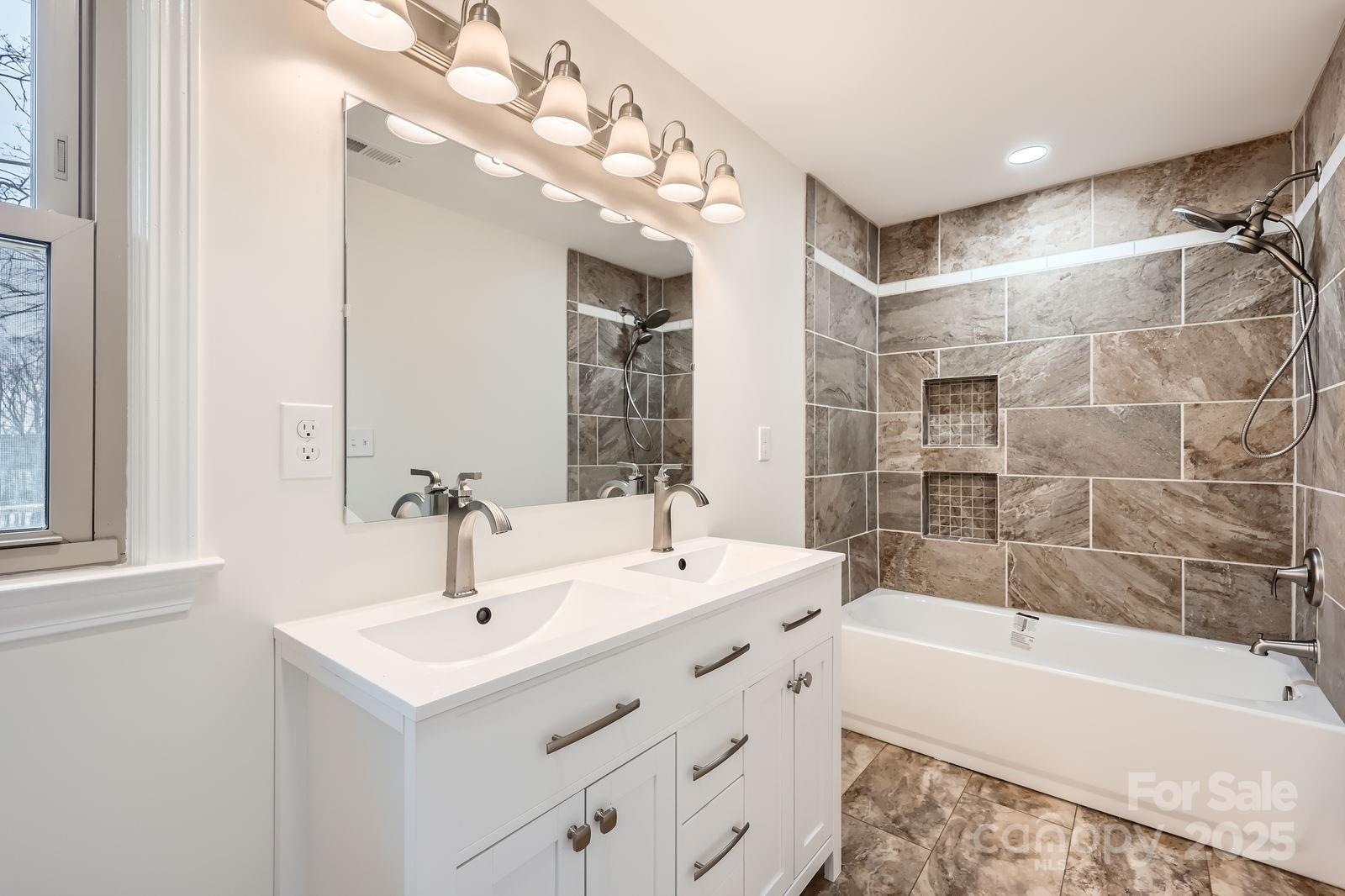 3225 Liberty Road Gold Hill, NC 28071 - Photo 11 of 24 a bathroom with a sink a large mirror and a bathtub with shower