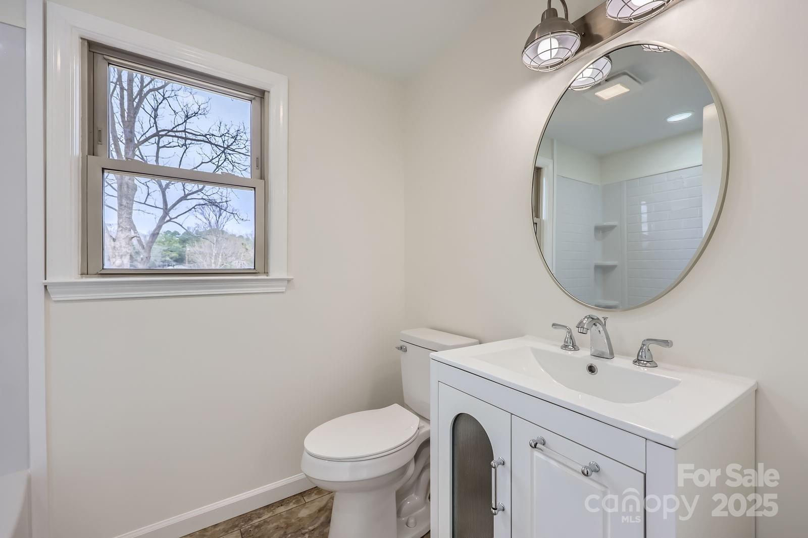 3225 Liberty Road Gold Hill, NC 28071 - Photo 13 of 24 a bathroom with a toilet sink and mirror