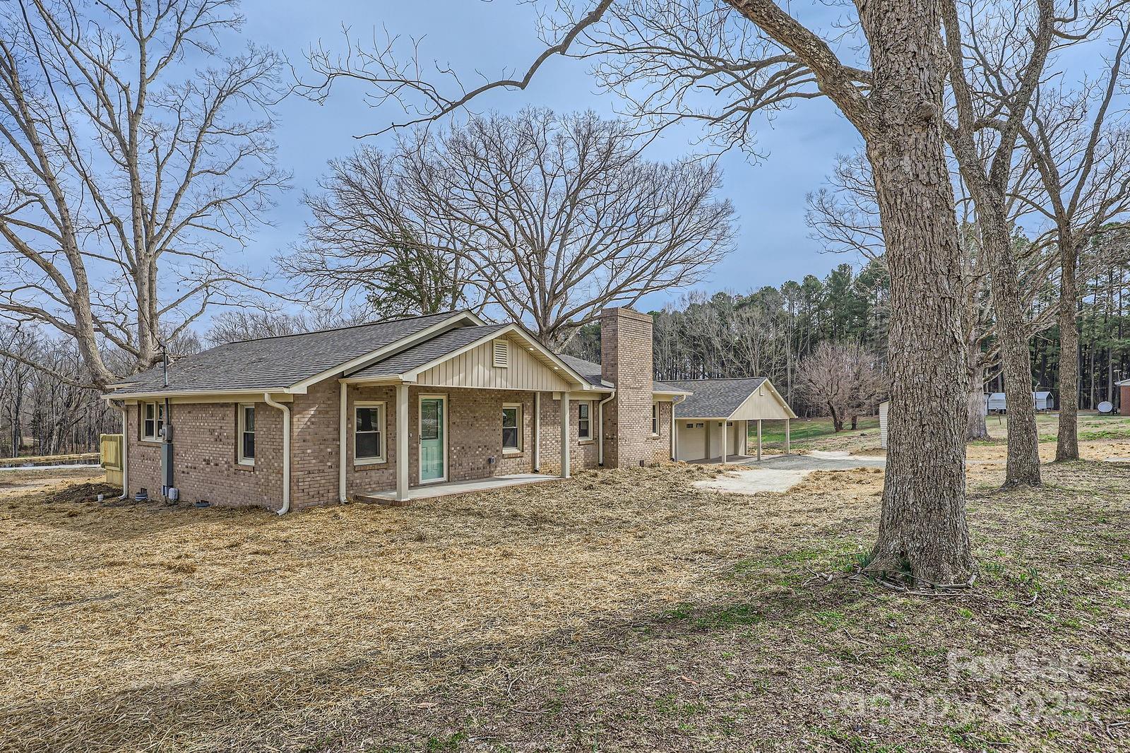 3225 Liberty Road Gold Hill, NC 28071 - Photo 2 of 24 a front view of a house with a yard and large trees