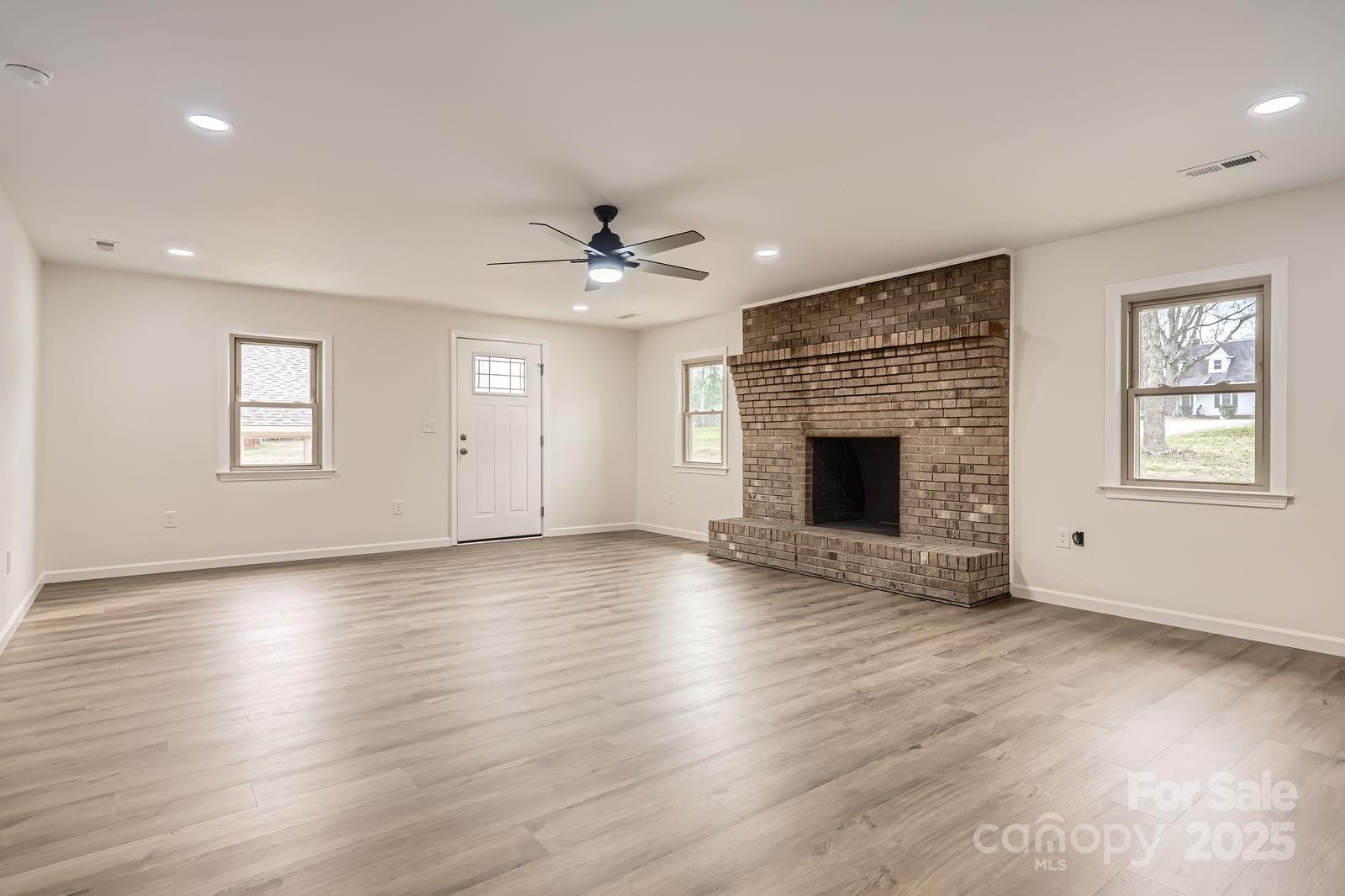 3225 Liberty Road Gold Hill, NC 28071 - Photo 3 of 24 an empty room with windows fireplace and windows