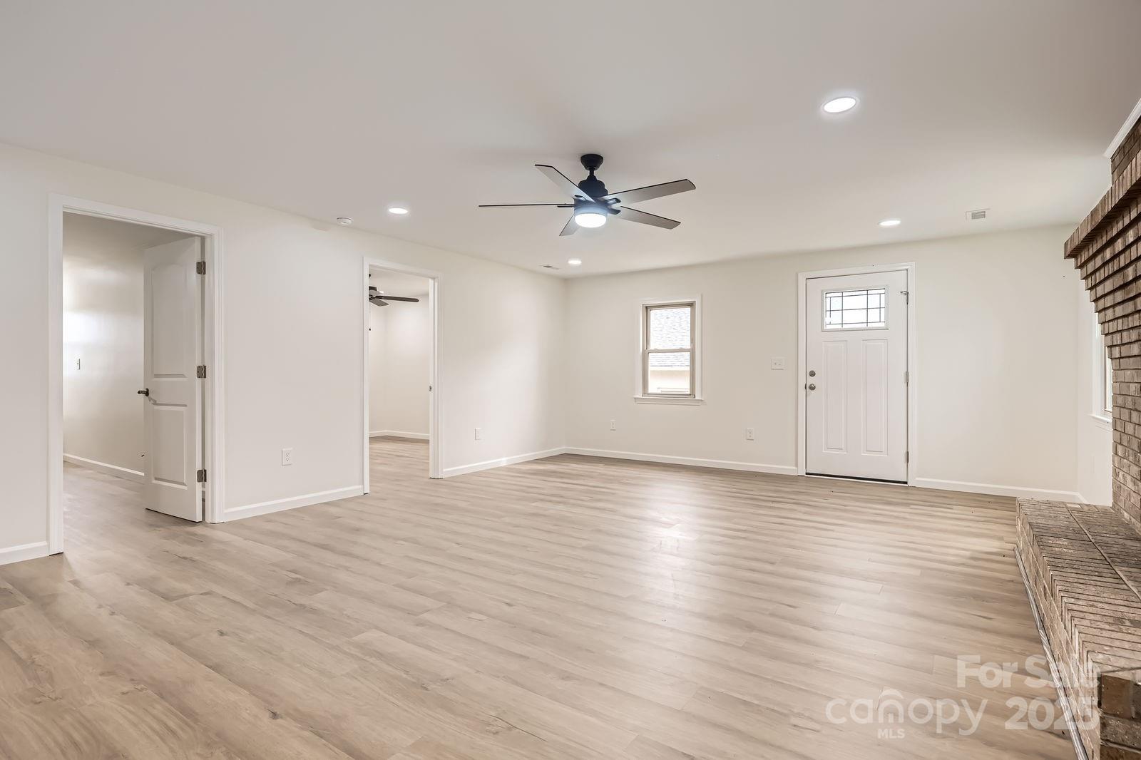 3225 Liberty Road Gold Hill, NC 28071 - Photo 4 of 24 a view of an empty room with window and wooden floor