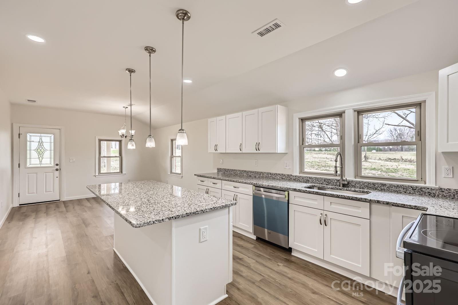 3225 Liberty Road Gold Hill, NC 28071 - Photo 6 of 24 a kitchen with granite countertop a sink a counter space appliances and cabinets
