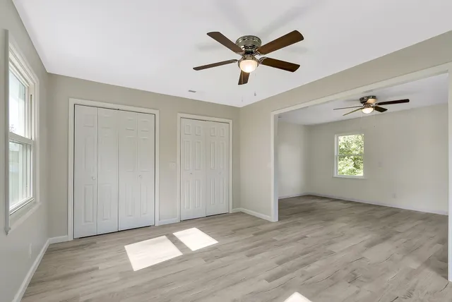 wooden floor in an empty room with a window