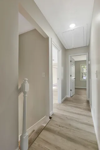a view of a room with wooden floor and bathroom