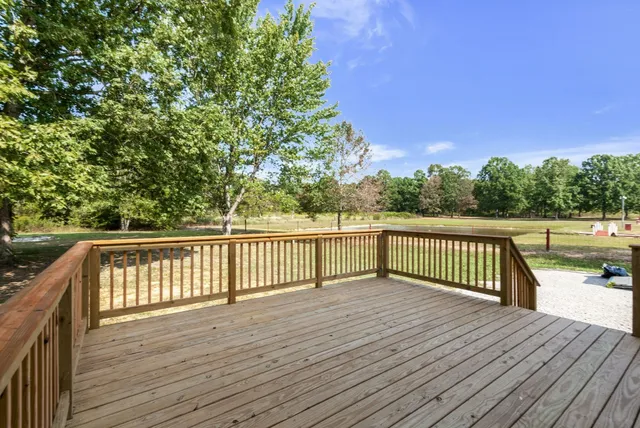 a view of deck with a large trees