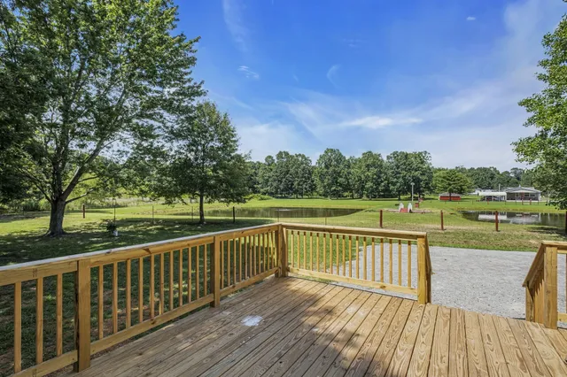 a view of balcony with wooden floor and fence