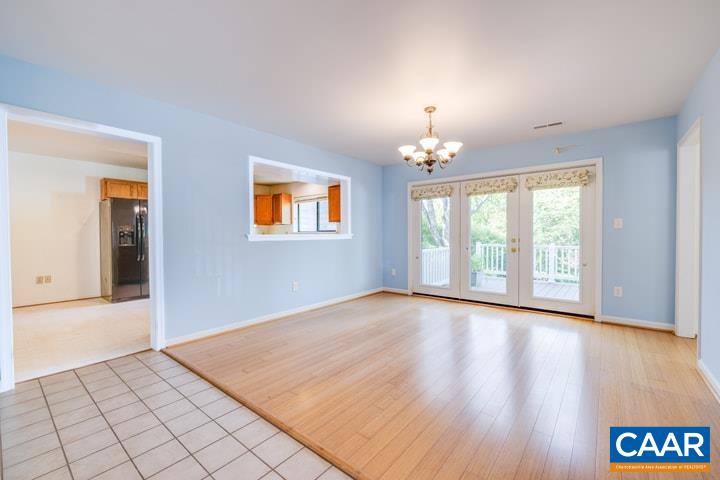 998 Amber Ridge Road Charlottesville, VA 22901 - Photo 5 of 22 a view of an empty room with window and wooden floor