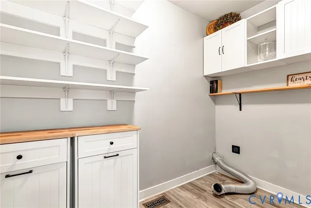 a view of a closet with wooden floor