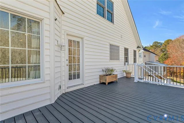 a backyard of a house with wooden floor and fence